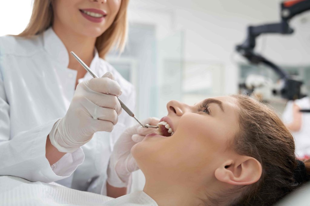 Dental hygienist performing a professional teeth cleaning in Houma, LA