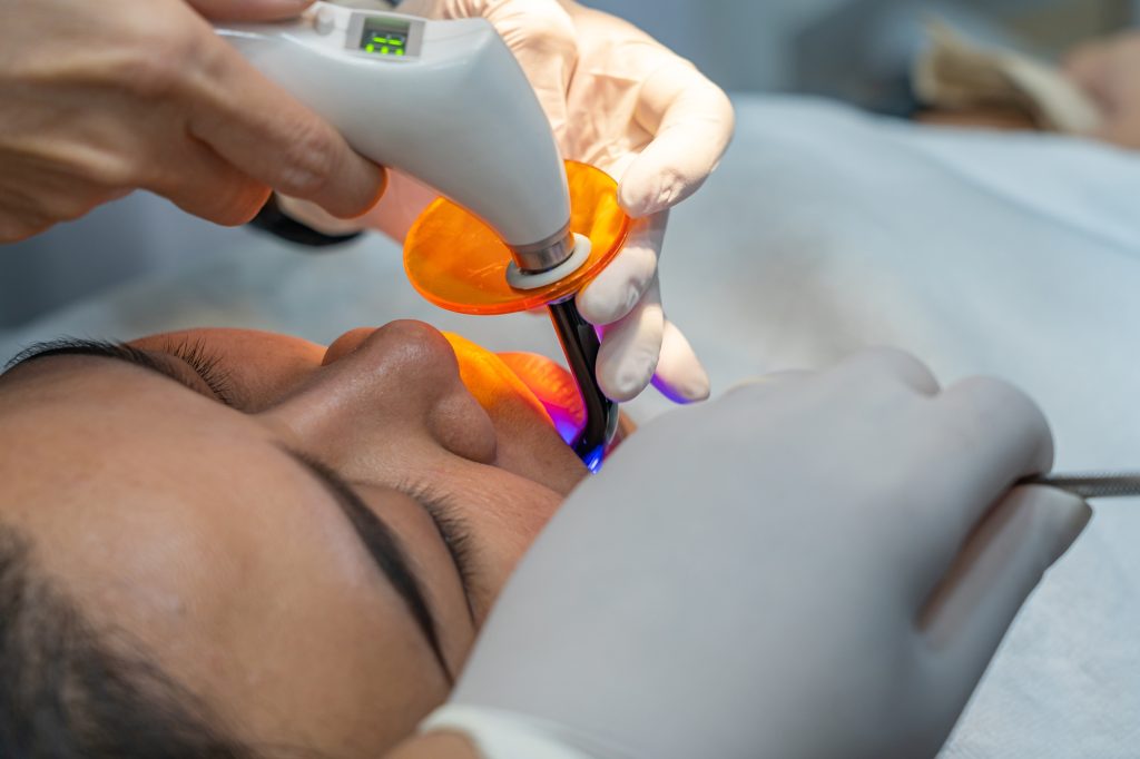 Dental hygienist performing a professional teeth cleaning on a patient